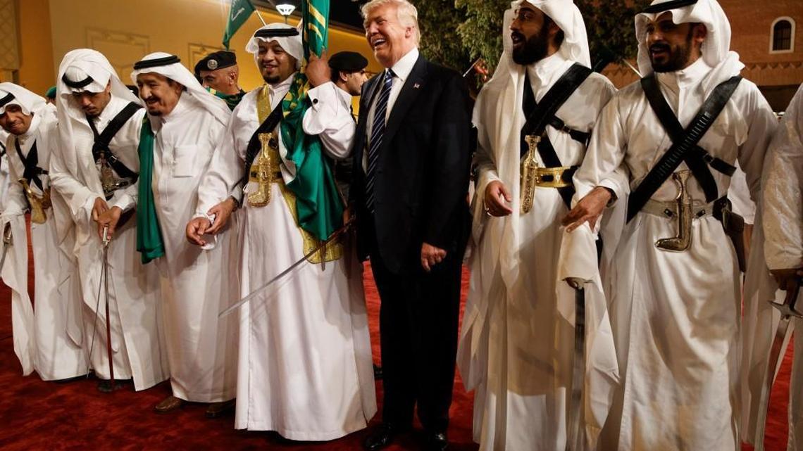 President Donald Trump held a sword and danced with traditional dancers during a welcome ceremony Saturday at Murabba Palace in Riyadh.