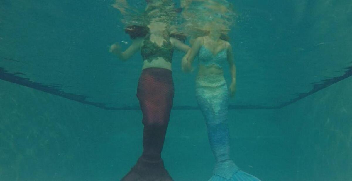 Moira Dobbs and Ashton Larson hit the pool in their monofins.