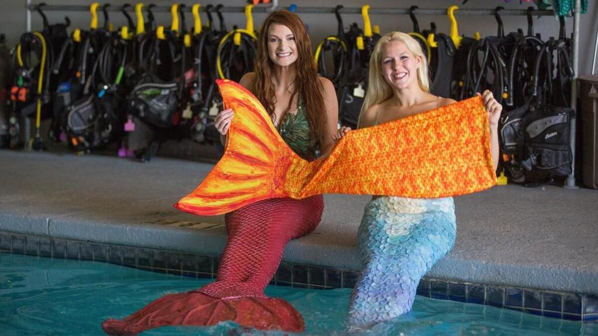 Moira Dobbs and Ashton Larson, from left, are professional mermaids at Adventure Scuba and Snorkeling Center of Plano.