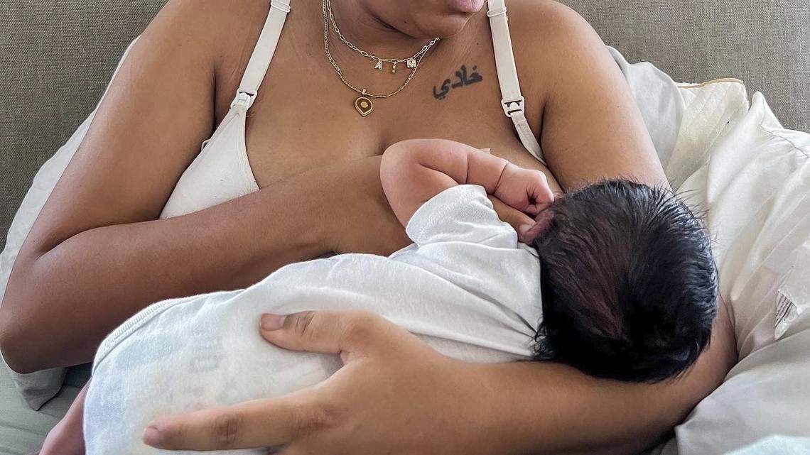 In this photo provided by Mark Godbolt Jr., his wife, Jade Godbolt, nurses her newborn child at their Dallas-area home in October 2022. She and her husband chose a home birth for their third child. A new study reveals that home births increased to their highest level in decades in 2021. (Mark Godbolt Jr. via AP)
