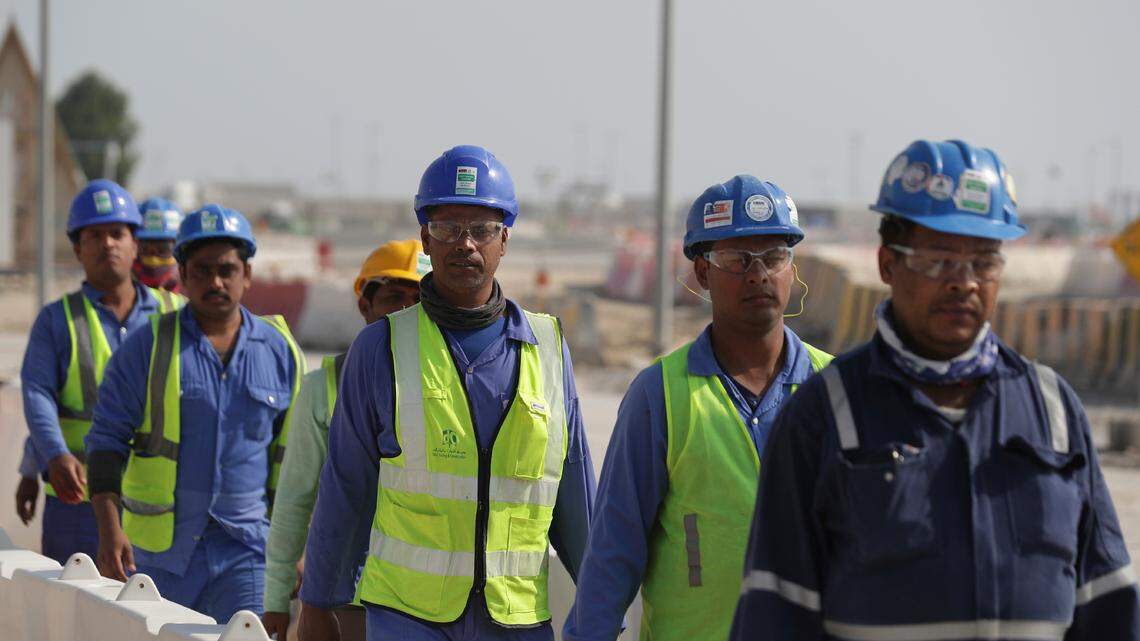 Workers walk to the Lusail Stadium, one of the 2022 World Cup stadiums, in Lusail, Qatar, Friday, Dec. 20, 2019. Between 400 and 500 World Cup workers died, according to a Qatari official. (AP Photo/Hassan Ammar)
