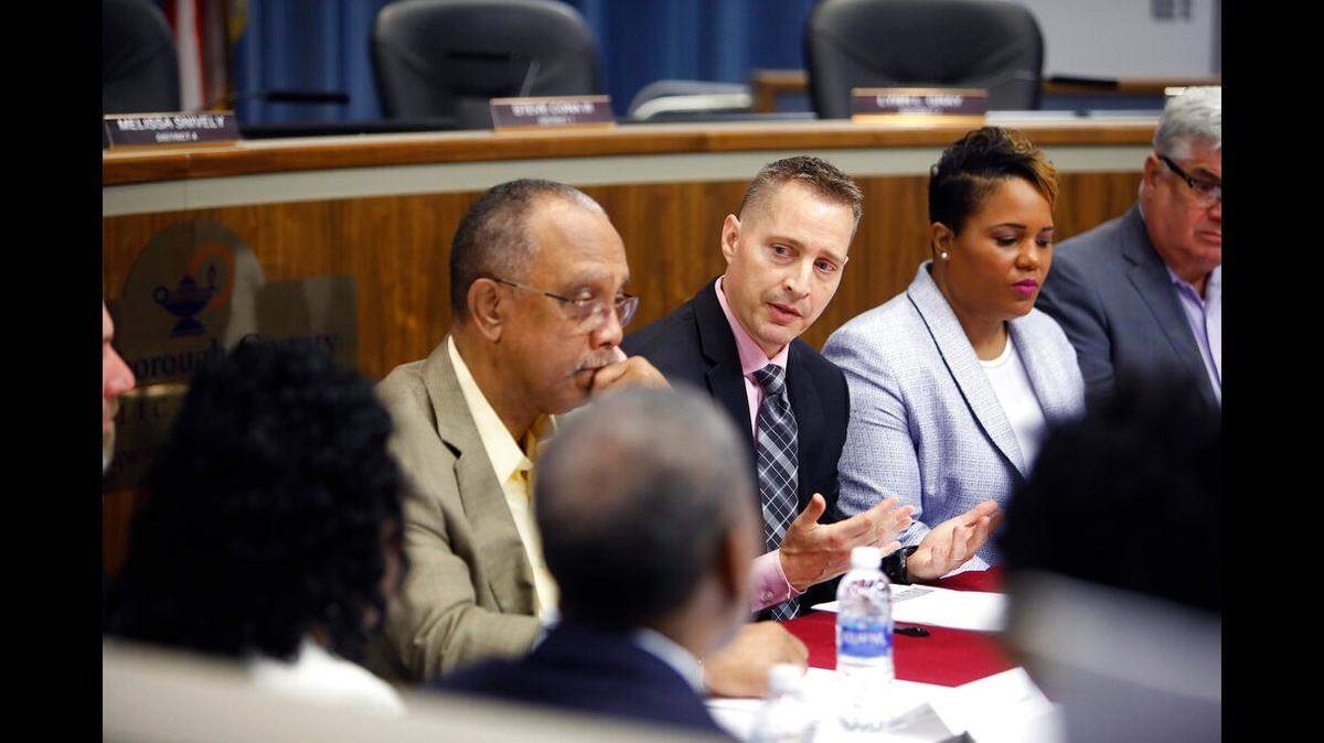 Jeff Eakins, center, superintendent of Hillsborough County Public Schools, speaks while County Commissioner Les Miller, left, and Tammy Shamburger, right, chair of the Hillsborough County Public Schools Board look on during the Ridgewood Cemetery Committee meeting in Tampa, Florida on Wednesday, November 20, 2019.