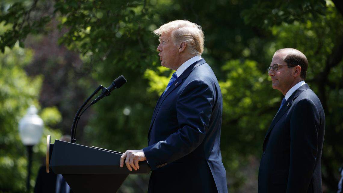 Secretary of Health and Human Services Alex Azar looks on as President Donald Trump speaks during an event about prescription drug prices in the White House Rose Garden on May 11, 2018.