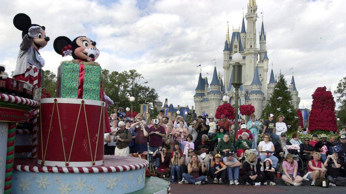 ** FILE ** Visitors gather in front of Cinderella’s castle to watch Mickey and Minnie Mouse during the Christmas parade at Walt Disney World’s Magic Kingdom in Lake Buena Vista, Fla, Dec. 22, 2004. A group of seven friends from Sydney _ all Disney fanatics organized a 32-day trip that takes them to every Disney park in the world _ from Tokyo to Hong Kong to Paris, to the U.S. flagships, Disneyland in Anaheim, Calif., and Walt Disney World near Orlando, Fla. (AP Photo/Peter Cosgrove)