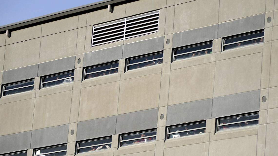 FILE - Prisoners crowd windows of the Etowah County Detention Center in Gadsden, Ala., Saturday, Dec. 3, 2011. Federal immigration authorities say they will stop housing detainees at the jail, citing a history of problems, and they will limit the use of three other detention centers in Florida, North Carolina and Louisiana. (Sarah Dudik/The Gadsden Times via AP)