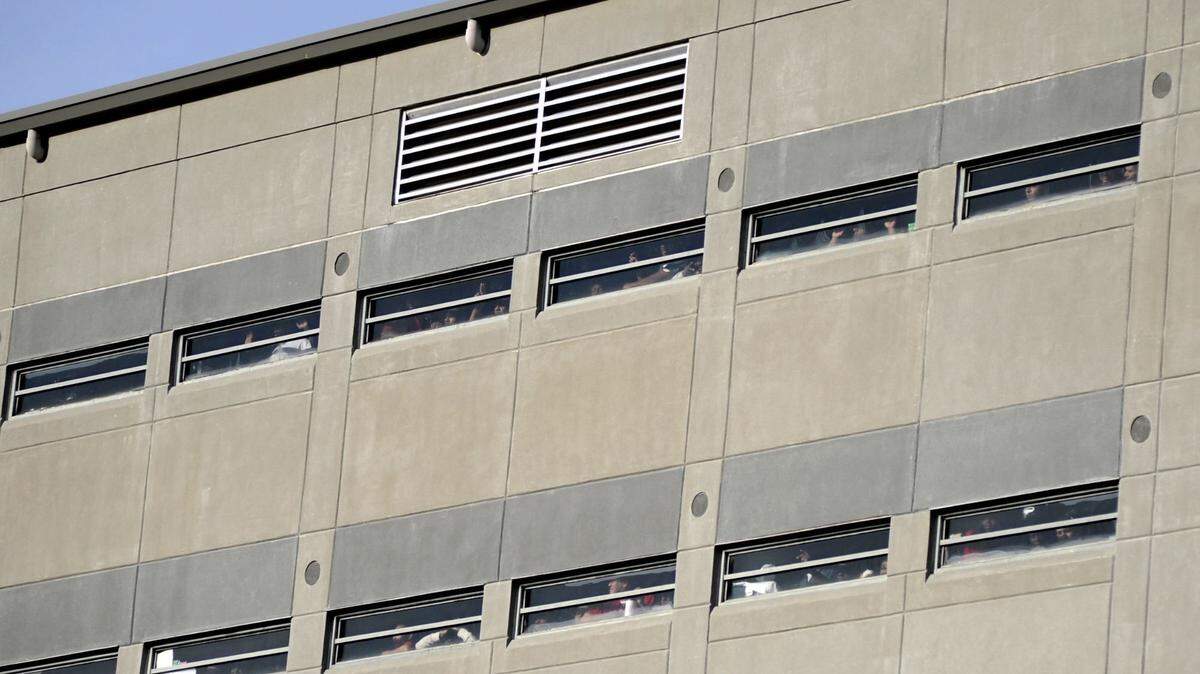 FILE - Prisoners crowd windows of the Etowah County Detention Center in Gadsden, Ala., Saturday, Dec. 3, 2011. Federal immigration authorities say they will stop housing detainees at the jail, citing a history of problems, and they will limit the use of three other detention centers in Florida, North Carolina and Louisiana. (Sarah Dudik/The Gadsden Times via AP)