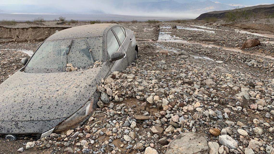 A car was swept off the road by flash floods in Death Valley, park officials said.