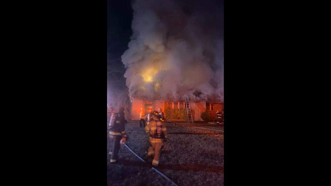 A woman trapped in a home during a fire died along with several dogs, South Carolina officials said. Two more people were injured.