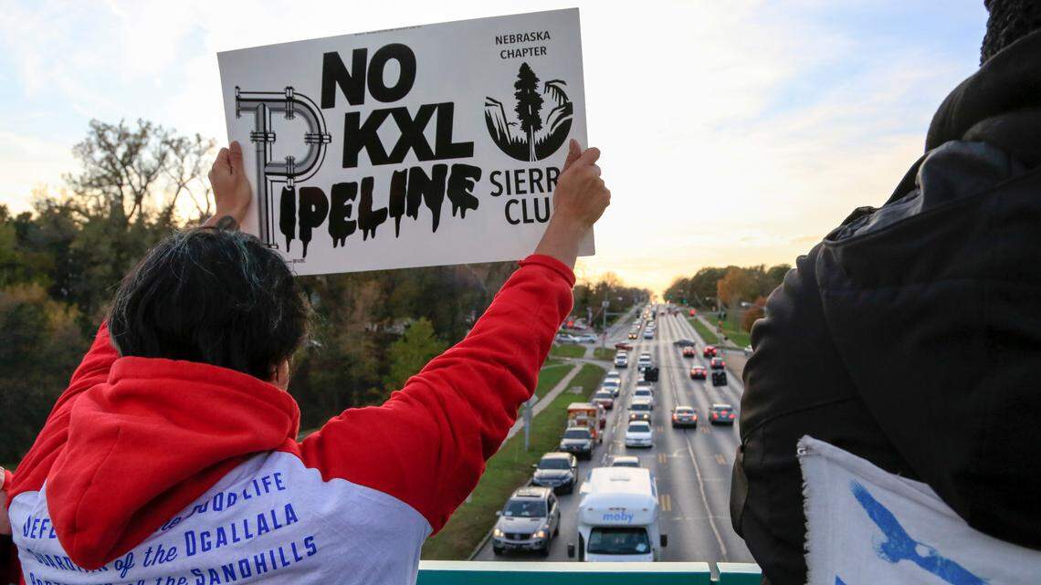 Opponents of the Keystone XL pipeline demonstrate on the Dodge Street pedestrian bridge during rush hour in Omaha, Neb., Wednesday, Nov. 1, 2017.
