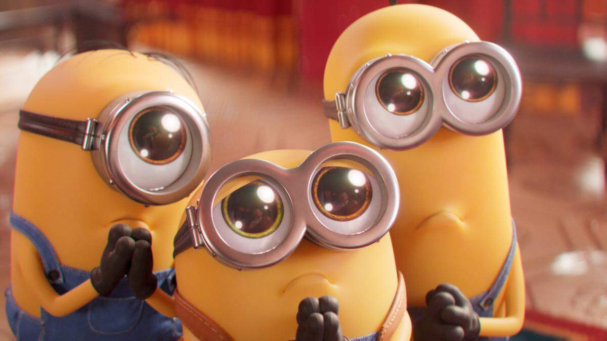 This image released by Universal Pictures shows Minions characters, from left, Stuart, Bob and Kevin in a scene from “Minions: The Rise of Gru.” The movie inspired the recent #gentleminions TikTok trend, which encourages teens and young adults to see the movie while dressed in suits. (Illumination Entertainment/Universal Pictures via AP)