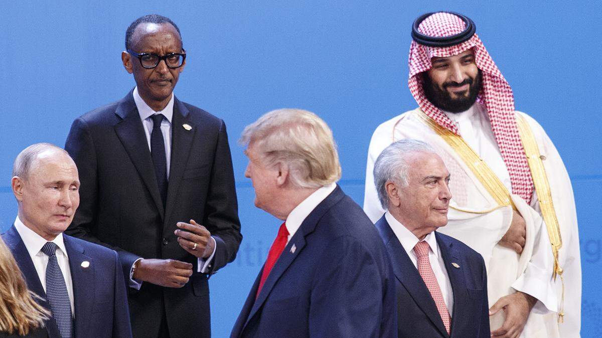 President Donald Trump, center, walks past President Vladimir Putin of Russia, left, and Crown Prince Mohammed bin Salman of Saudi Arabia, right, while lining up with world leaders for a group photo at the G-20 summit, at the InterContinental hotel in Buenos Aires, Argentina, Nov. 30, 2018. (Tom Brenner/The New York Times)