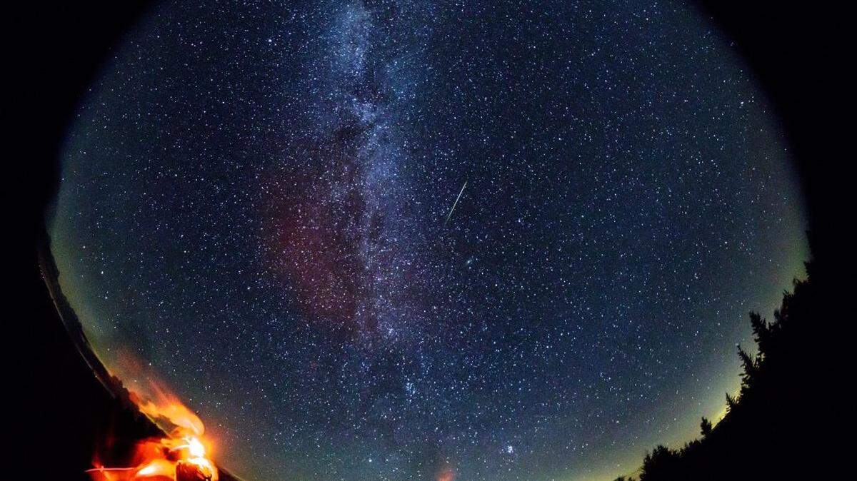 In this 30-second exposure taken with a circular fish-eye lens, a meteor streaks across the sky during the annual Perseid meteor shower on Friday, Aug. 12, 2016, in Spruce Knob, West Virginia.