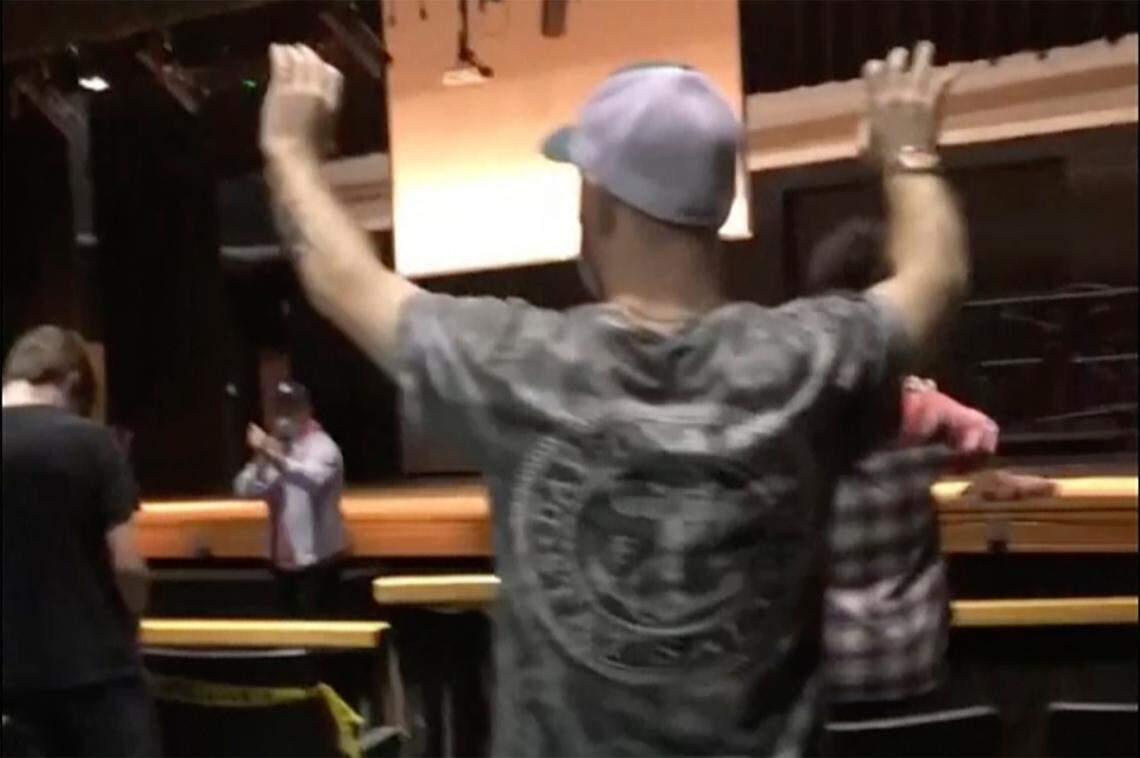 In this image taken from cell photo video, evangelical preacher Nik Walker of Nik Walker Ministries, second left, talks to high school kids during assembly at the Huntington High School Feb. 2, 2022, Huntington, West Virginia. Students from the school are planning to stage a walkout after they say they were made to attend the Christian assembly during school hours.