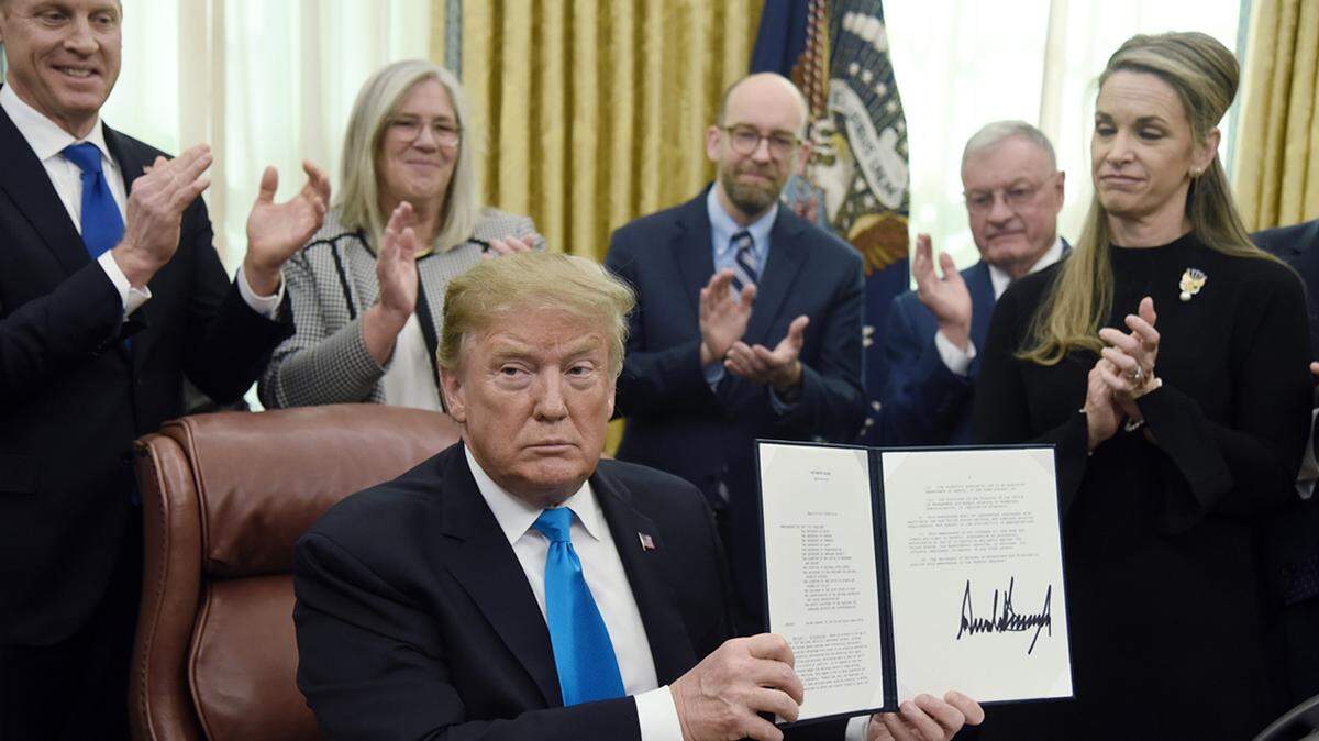 U.S. President Donald Trump holds a signed directive centralizing all military space functions under a new Space Force on Feb. 19.