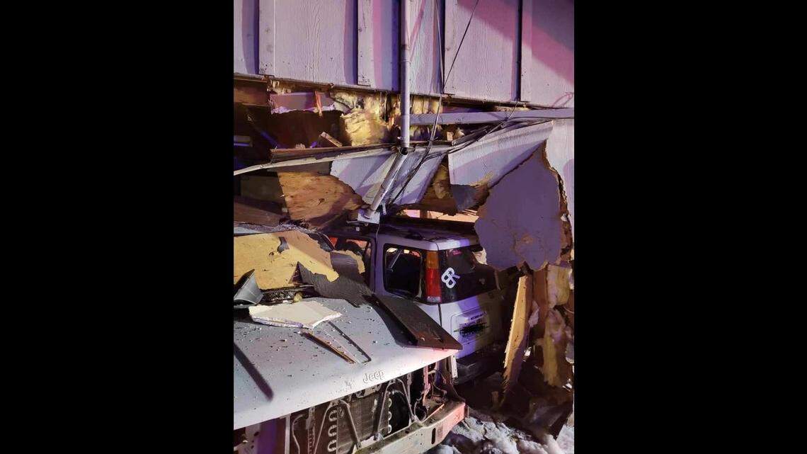 An SUV hit a Jeep parked outside a house, pushing it through the exterior and interior walls of the home, Washington officials said.