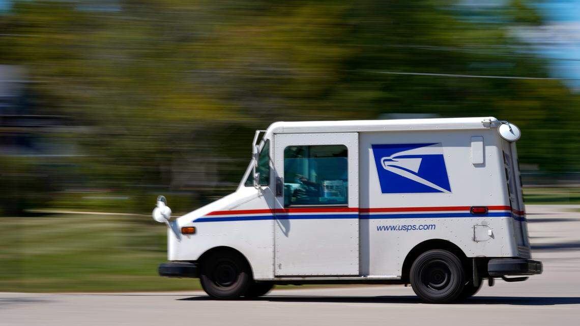 A mail truck moves down a street Tuesday, Aug. 18, 2020, in Fox Point, Wis. Mail service was suspended in one Santa Monica neighborhood after USPS said several of its mail carriers were attacked on the job. (AP Photo/Morry Gash)