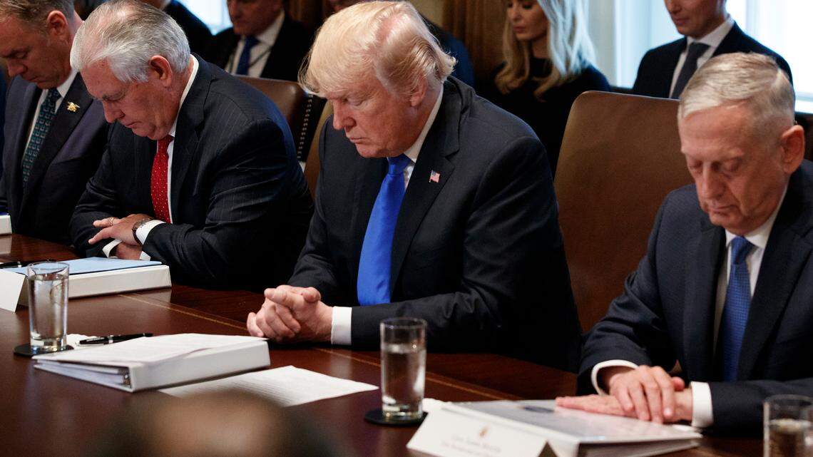 President Donald Trump prays during a cabinet meeting at the White House in 2017.