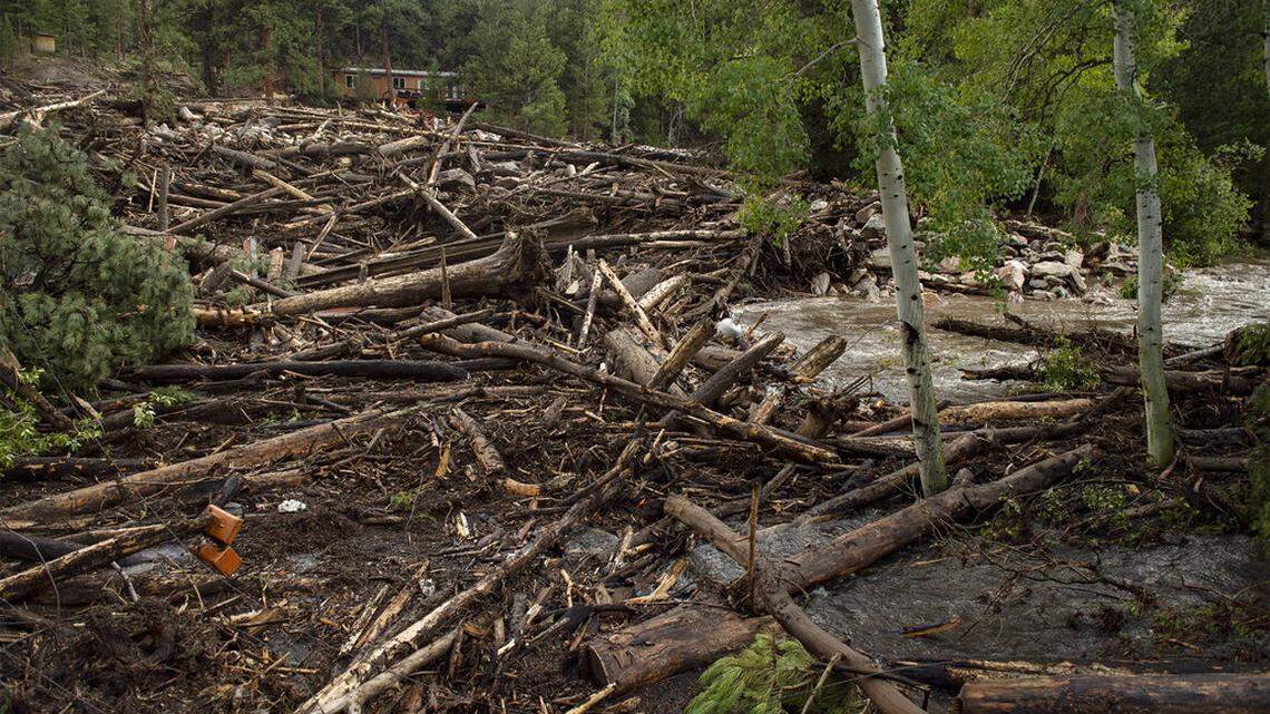 A debris field clogs the Cache La Poudre River after flash flooding ripped through a drainage near Black Hollow Road in the Poudre Canyon near Rustic, Colo. on Wednesday, July 21, 2021. (Bethany Baker/The Coloradoan via AP)