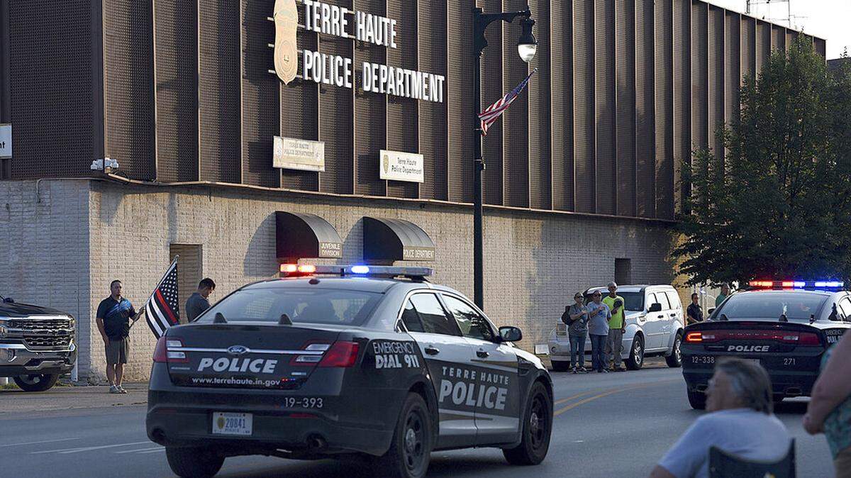 Dozens of officers and personnel from various law enforcement and rescue agencies drive past the Terre Haute Police Department during a during a fallen officer procession, Wednesday, July 7, 2021, in Terre Haute, Ind. Terre Haute Police Det. Greg Ferency, a 30-year department veteran who had been a federal task force officer since 2010, was killed in an ambush shooting outside an FBI office in western Indiana, an FBI official said Thursday, July 8, 2021. (Joseph C. Garza/The Tribune-Star via AP)