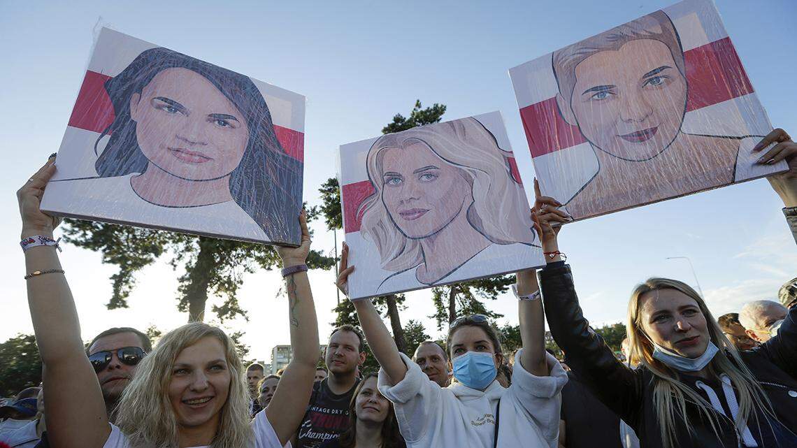 People hold portraits of Svetlana Tikhanovskaya, candidate for the presidential elections, left, wife of non-registered candidate Valery Tsepkalo, Veronika Tsepkalo, centre, Maria Kolesnikova, a representative of Viktor Babariko, right, during a meeting in Borisov, Belarus, Thursday, July 23, 2020. The longtime leader of Belarus President Alexander Lukashenko warned Thursday that Western media could be expelled from the country over what he described as their “tendentious” coverage of the presidential election next month in which he is seeking a sixth term. The presidential election in Belarus is scheduled for August 9, 2020. (AP Photo/Sergei Grits)