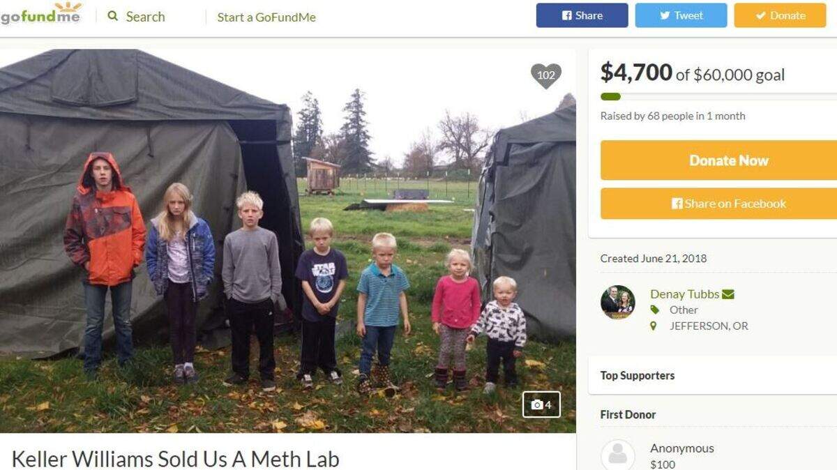 The Tubbs’ seven children stand outside tents on the property of the home their parents bought over a year ago. They are living in trailers on the property but can’t live in their home, because it’s contaminated with meth residue.