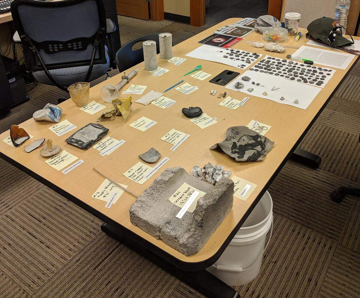 Yellowstone National Park officials lay out the human-made waste found littered around Ear Spring after its Sept. 15 eruption.