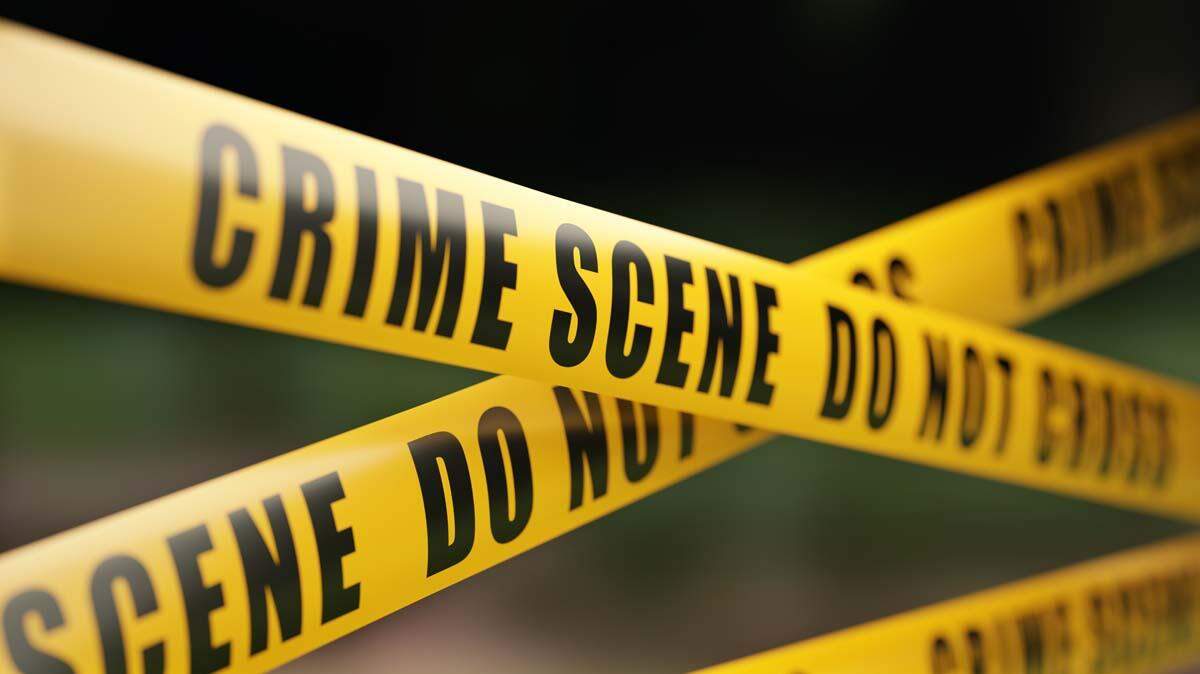 Police say they are investigating after a body was found inside a suspicious box near an empty house in Baltimore.