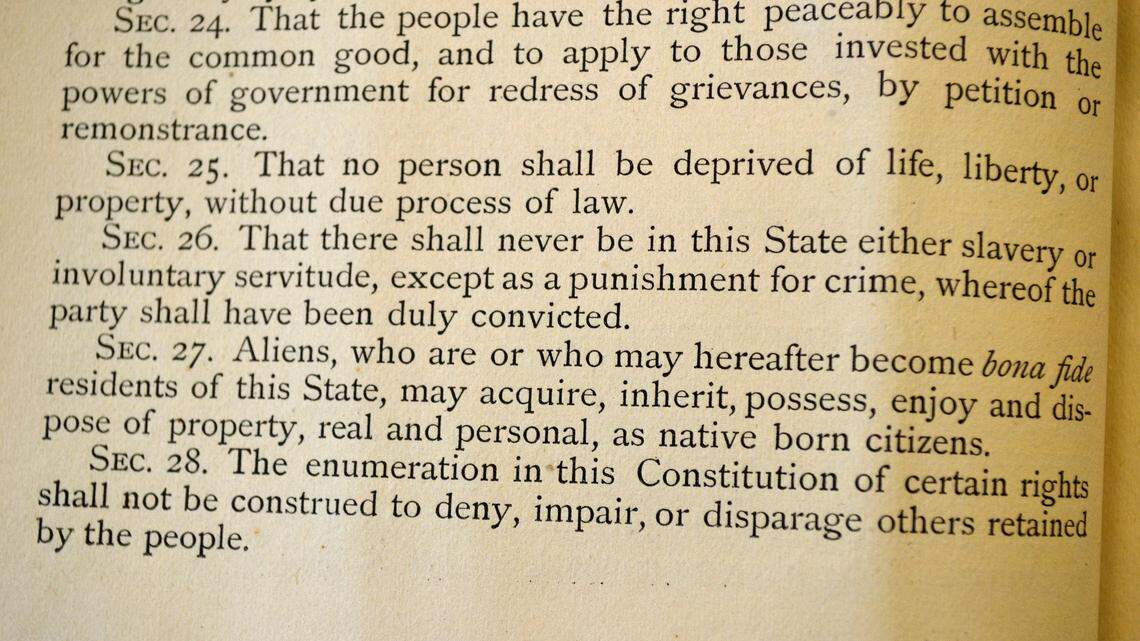 A close-up of an 1876 copy of the Colorado Constitution shows an exception under which slavery could be used as punishment for a crime.