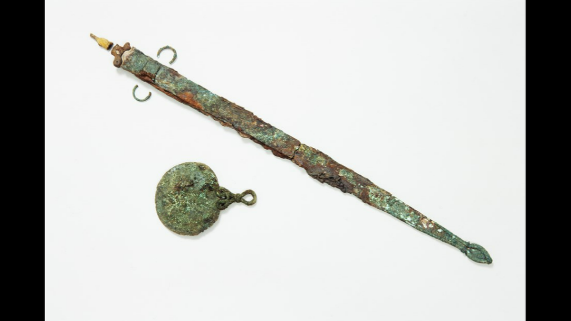 A bronze mirror was found with the iron sword, scientists said.