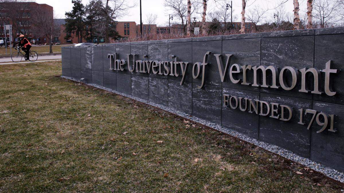 FILE - A bicyclist is seen on the campus of the University of Vermont in Burlington, Vt., Wednesday, March 11, 2020. The U.S. Department of Education is investigating allegations of antisemitism at the University of Vermont, including that some Jewish students were excluded from campus clubs and a teaching assistant threatened to reduce the grades of students who support the state of Israel. (AP Photo/Charles Krupa, File)