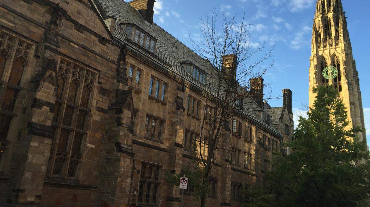FILE - This Sept. 9, 2016 photo shows Harkness Tower on the campus of Yale University in New Haven, Connecticut. A former Yale School of Medicine employee was sentenced to nine years in prison on Oct. 13 after she was accused of stealing $40 million, according to federal officials.