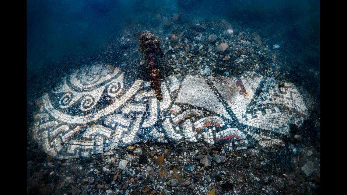 Experts noticed colored tiles beneath the sand and found an entire mosaic was buried.