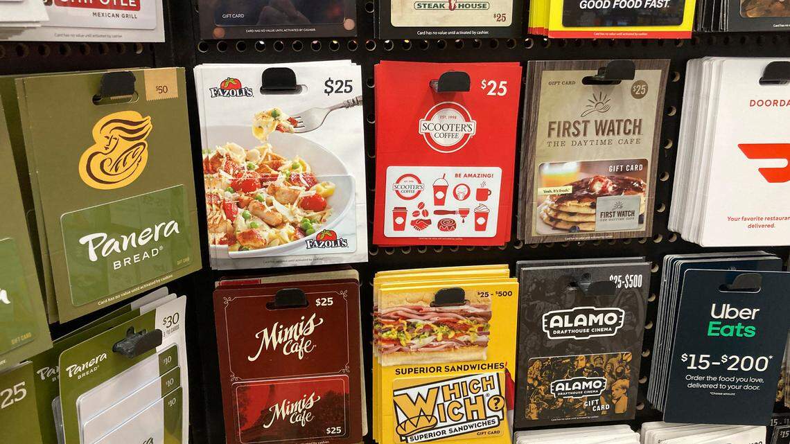 Gift cards are displayed on a rack in a grocery store Tuesday, Nov. 16, 2021, in southeast Denver. (AP Photo/David Zalubowski)