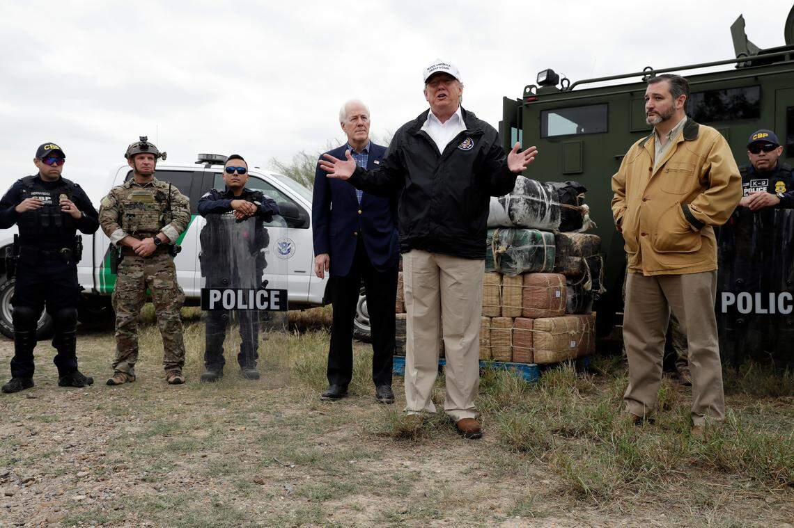 President Donald Trump speaks as he tours the U.S. border with Mexico at the Rio Grande on the southern border on Jan. 10, 2019, in McAllen, Texas, alongside Sen. John Cornyn, R-Texas, left, and Sen. Ted Cruz, R-Texas. (AP Photo/ Evan Vucci)