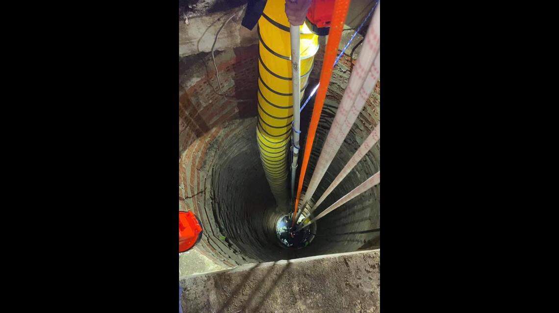 The firefighter was lowered deep into the 40-foot well where the dog named Rico waited at the bottom. Photo from Prairietown Fire Department on Facebook.