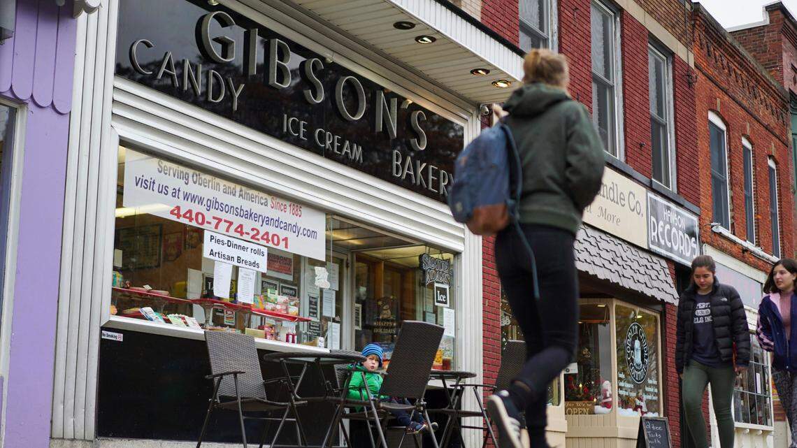 FILE - In this Nov. 22, 2017 file photo, pedestrians pass the storefront of Gibson’s Bakery in Oberlin, Ohio. The 9th District Court of Appeals upheld a $31 million judgment against Oberlin College that had been awarded to the bakery that successfully claimed it was libeled by the school after a shoplifting incident.