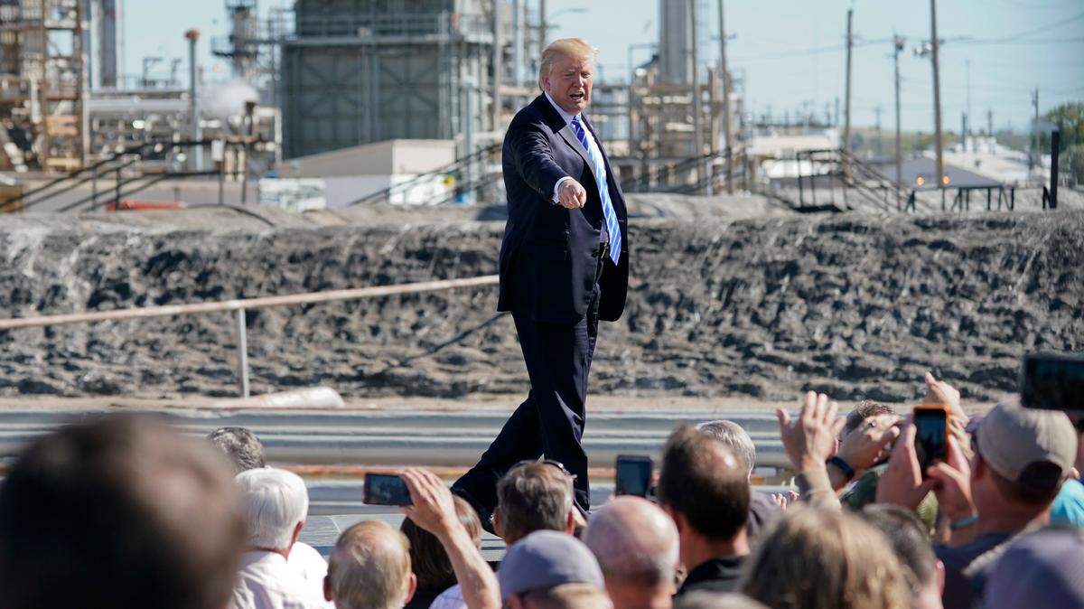 President Donald Trump points as he walks off stage after speaking at a Mandan, North Dakota, oil refinery last year. A man outside was arrested with a stolen forklift, and prosecutors said he admitted he planned to flip the president’s limousine with it.