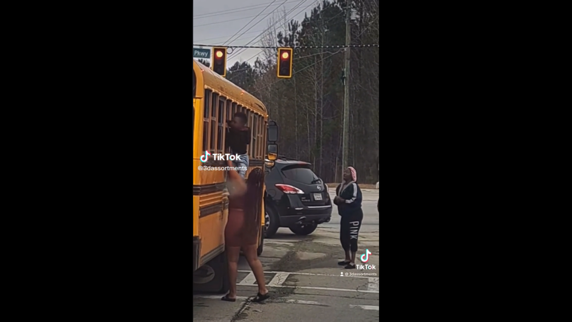 A viral TikTok video shows kids climbing out school bus windows as it sat at a red light after a parent slapped the driver.