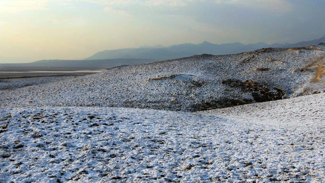 Photo of a snow-like dusting at Death Valley National Park in California was caused by rain soaking into the soil and dissolving salt beneath the surface, rangers said.