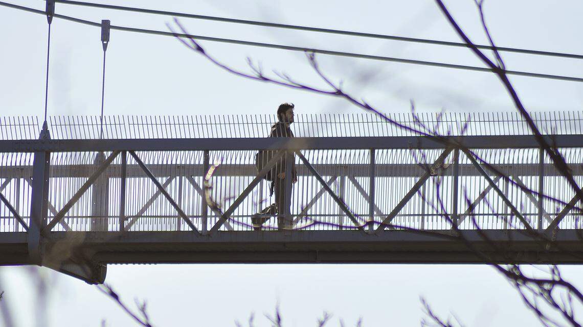 In this photo taken March 16, 2010, a Cornell University student walks across the Suspension Pedestrian bridge along the college’s North campus in Ithaca, New York. A man drowned under a waterfall near the bridge on Oct. 11, according to Ithaca police.