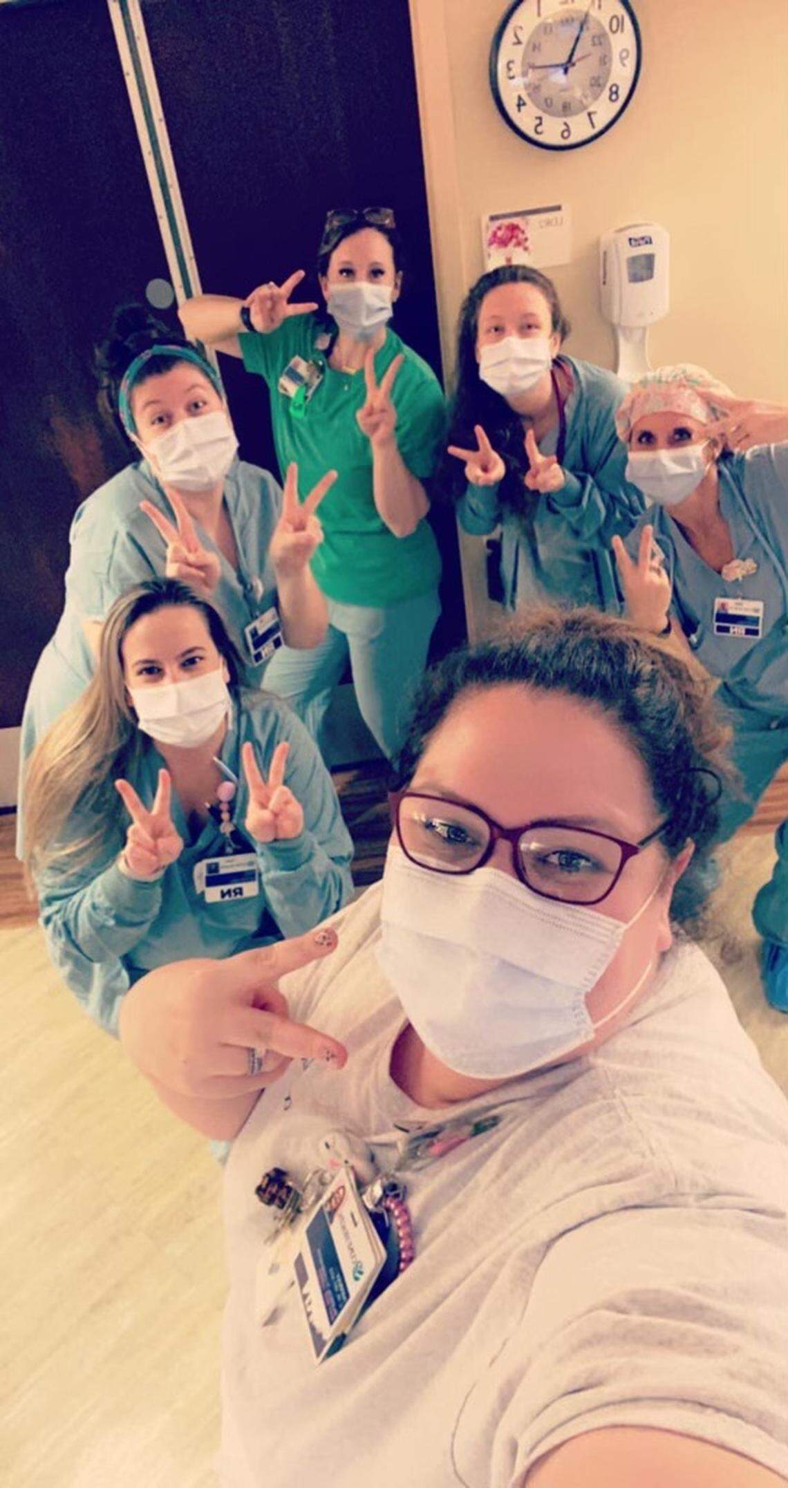 Staff at the Alamance Regional Medical Center celebrate the birth of Judah Grace by pointing their fingers in twos.