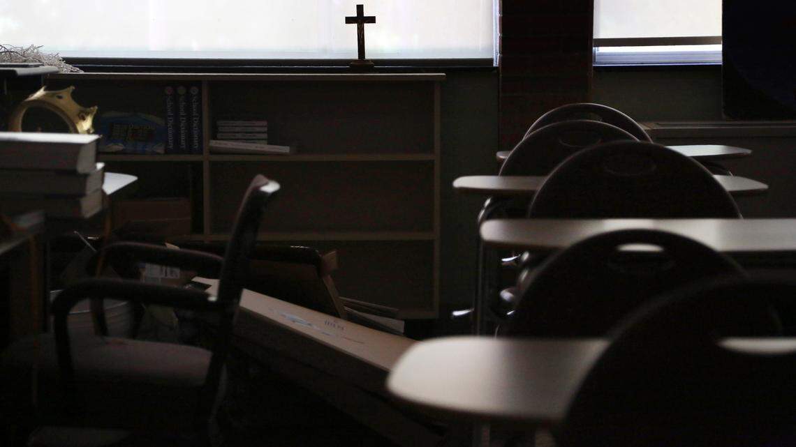 In this Monday, June 8, 2020 file photo, a cross sits in the window of an empty classroom at a Catholic high school. A Catholic friar who was a teacher and principal at the St. Francis School in Greenwood during the 1990s sexually assaulted multiple students, a Mississippi jury found. He was just sentenced to 45 years in prison without parole.