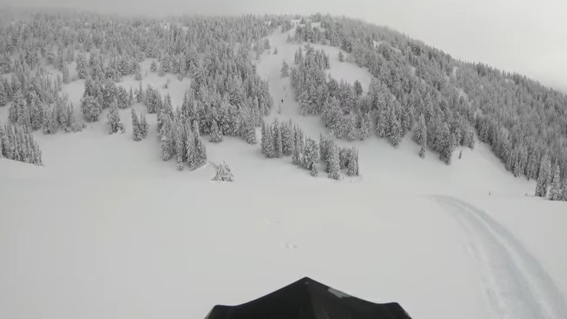 A snowmobiler was buried in an avalanche in Wyoming, video shows.