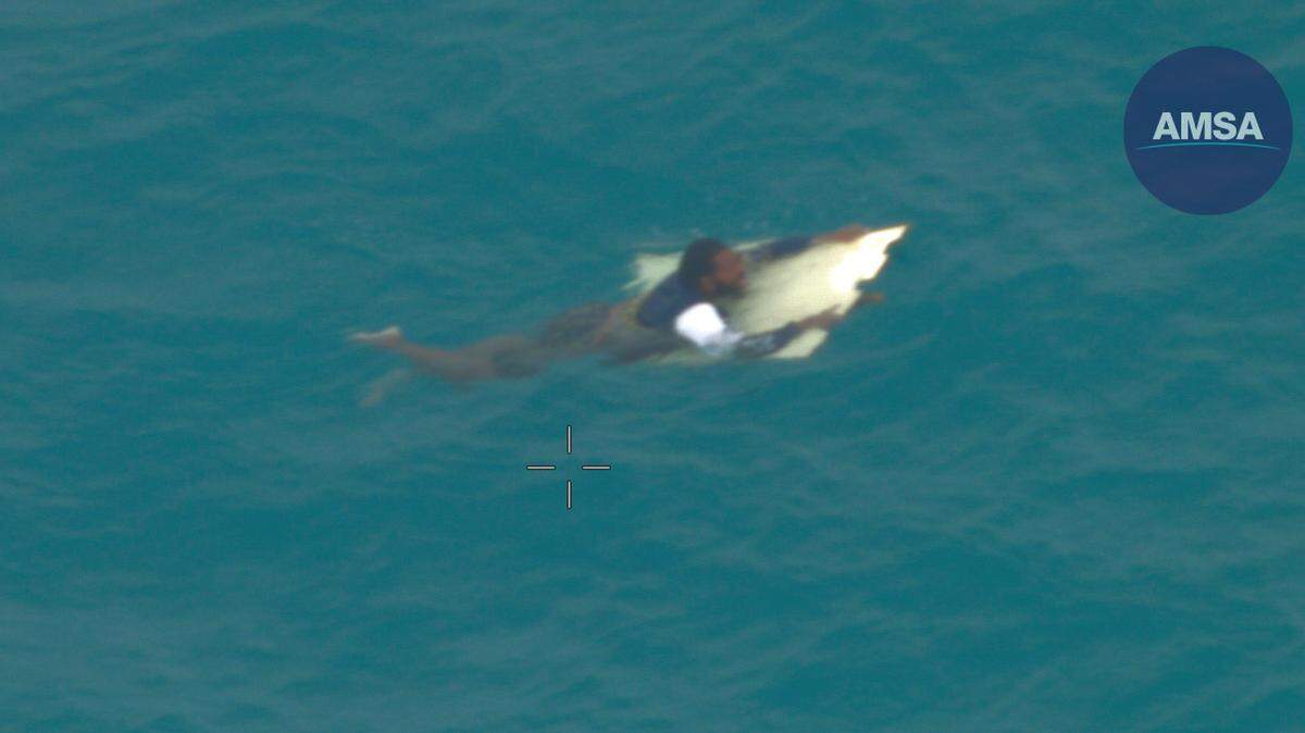 A man was rescued by a helicopter after surviving 20 hours at sea, Australian officials said.