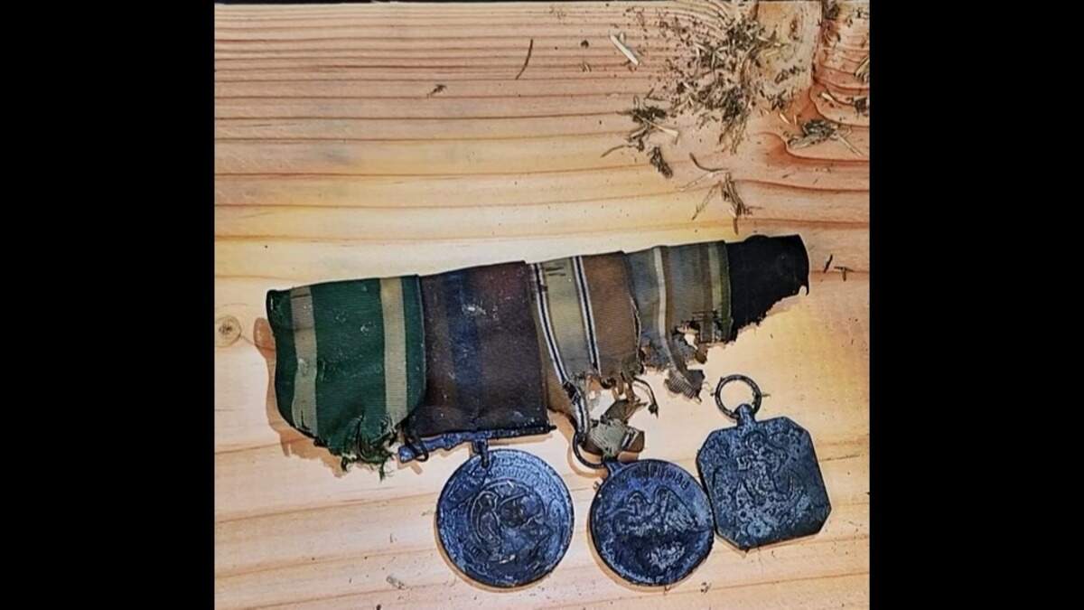 Military medals that were buried with Cooper had been badly damaged, his family’s lawyer said.