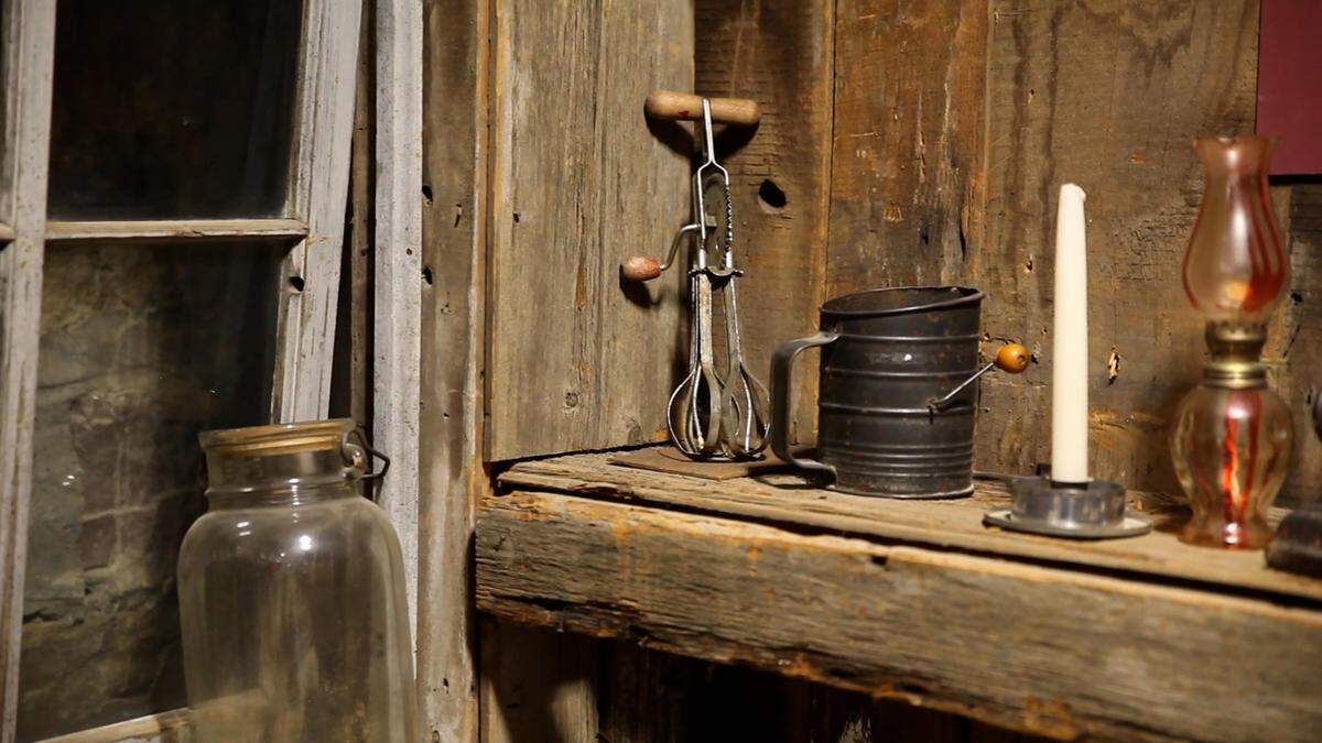An old hand crank mixer, a candlestick and other items owned by Lucy A. Willis on display in Lucy's Cabin at The Black Archives of Mid-America.