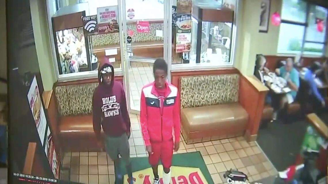 Surveillance video shows two males walk into a Denny's restaurant two days before a woman's body was found in her garage.