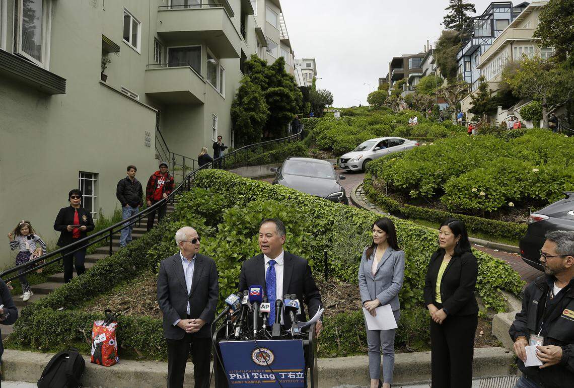 State Assemblyman Phil Ting talks about a bill he authored allowing the city to have a reservation and pricing system to drive on Lombard Street in San Francisco. Listening third from right is San Francisco Supervisor Catherine Stefani.