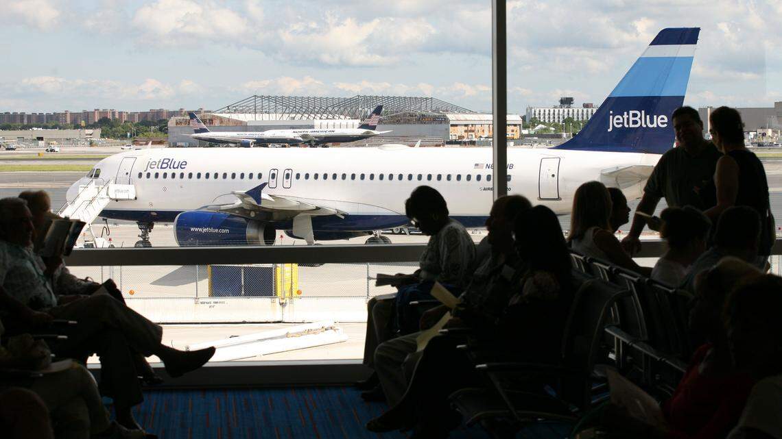 In this Aug. 23, 2008 file photo, travelers sit at a gate in JetBlue Airways’ new Terminal 5 at John F. Kennedy International Airport in New York.