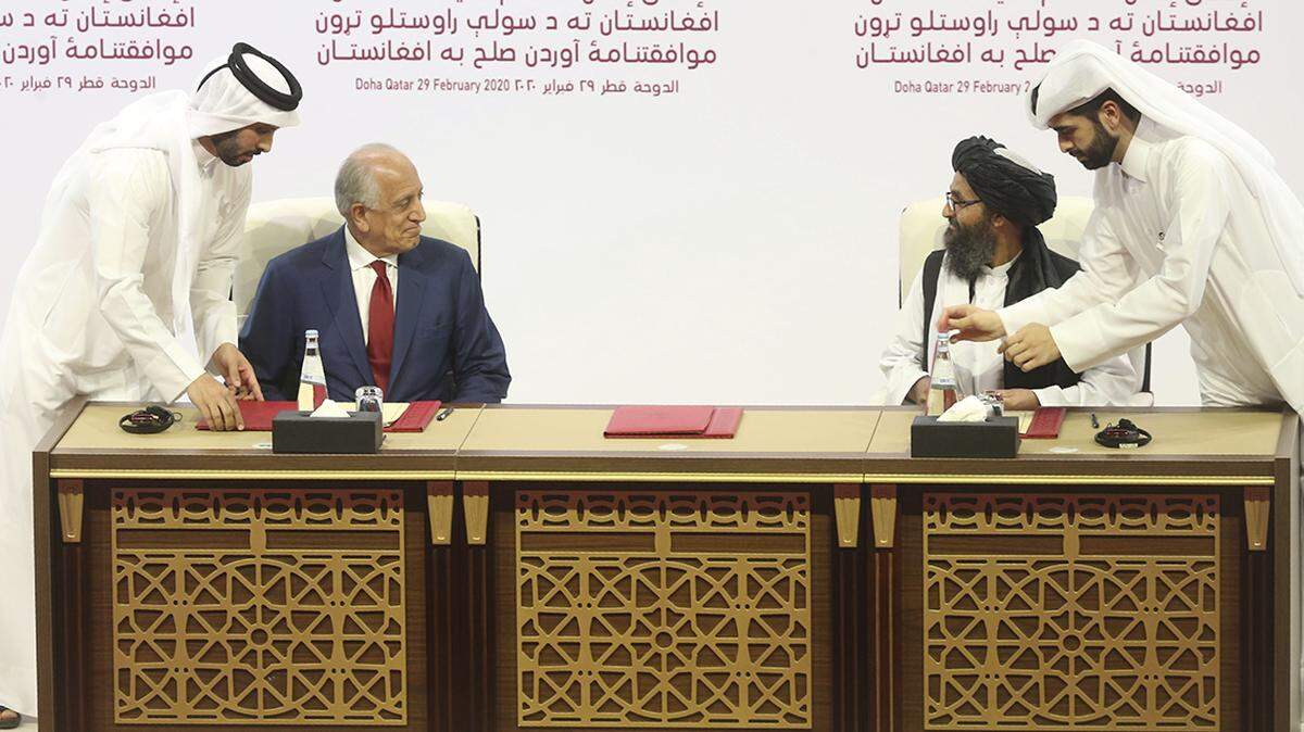 U.S. peace envoy Zalmay Khalilzad, left, and Mullah Abdul Ghani Baradar, the Taliban group’s top political leader sign a peace agreement between Taliban and U.S. officials in Doha, Qatar, Saturday, Feb. 29, 2020. The United States is poised to sign a peace agreement with Taliban militants on Saturday aimed at bringing an end to 18 years of bloodshed in Afghanistan and allowing U.S. troops to return home from America’s longest war. (AP Photo/Hussein Sayed)